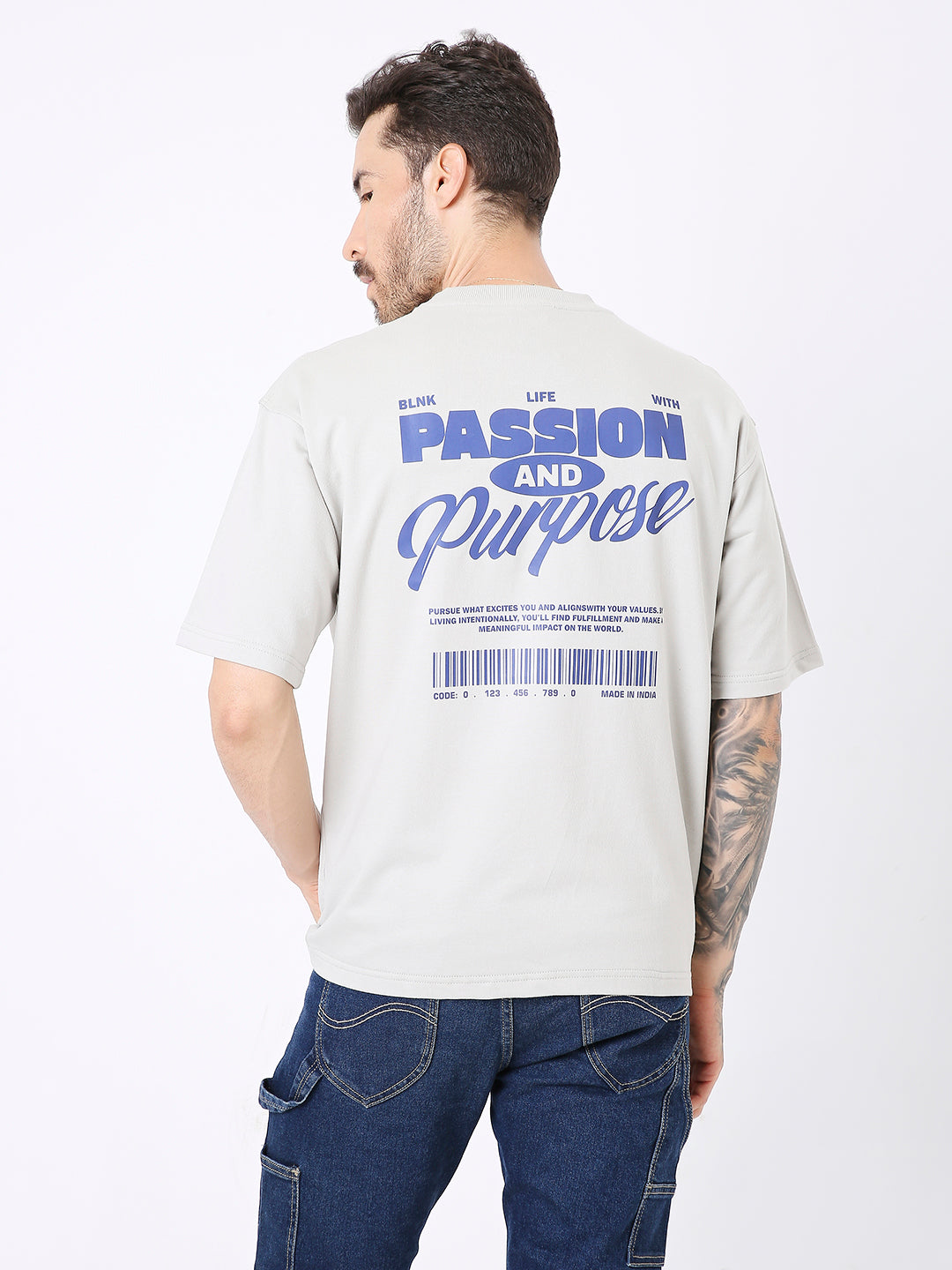 Light beige oversized t-shirt with blue "Passion and Purpose" text and barcode graphic on the back.
