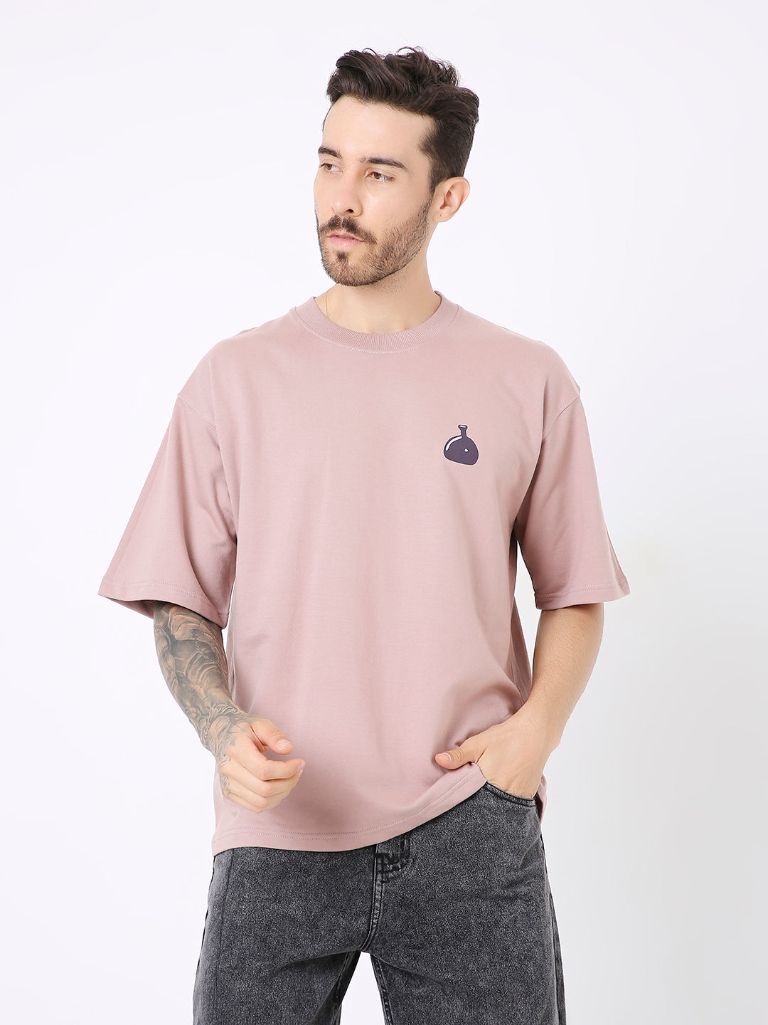 Oversize onion pink t-shirt with small black onion graphic on chest, worn by male model.