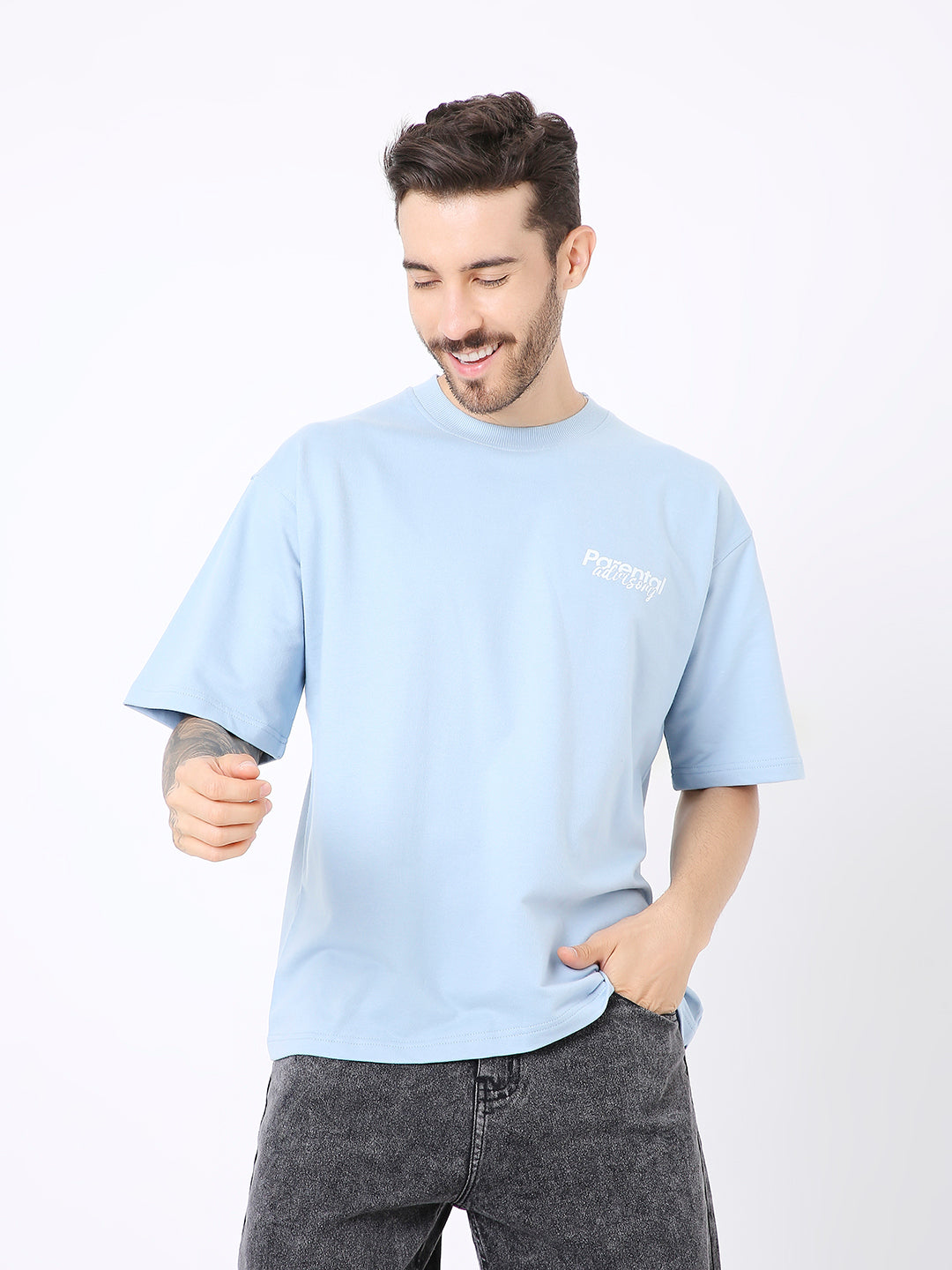 Oversize light blue t-shirt with small white chest print, relaxed fit, short sleeves.