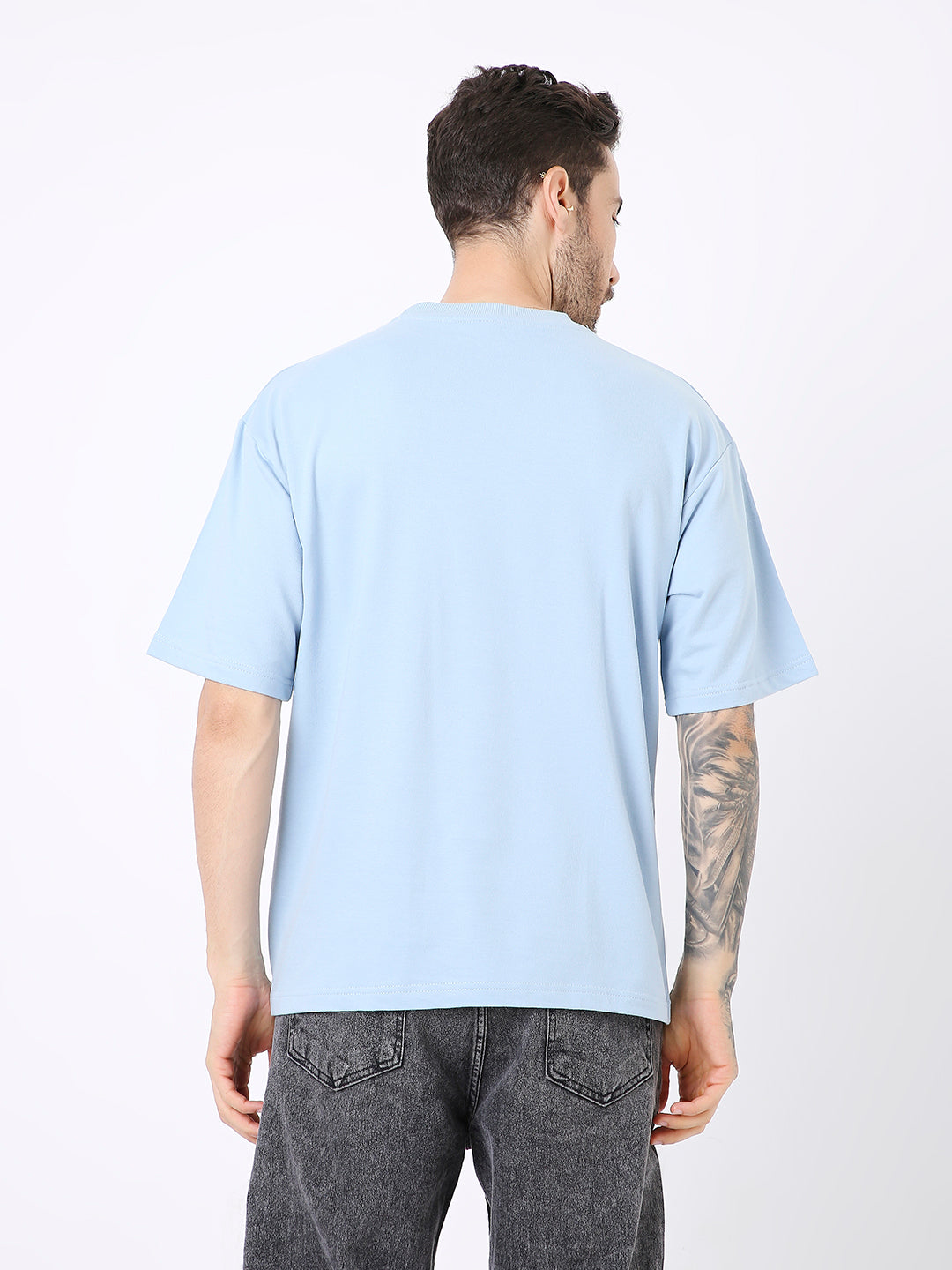 Oversize light blue solid short-sleeve t-shirt with a relaxed fit shown from the back.