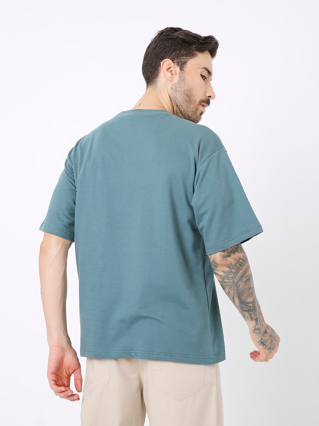 Oversize sapphire blue solid short-sleeve t-shirt on male model, back view.