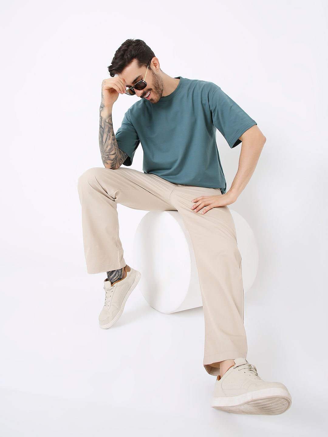 Oversize sapphire blue short-sleeve t-shirt styled with beige pants and sneakers.