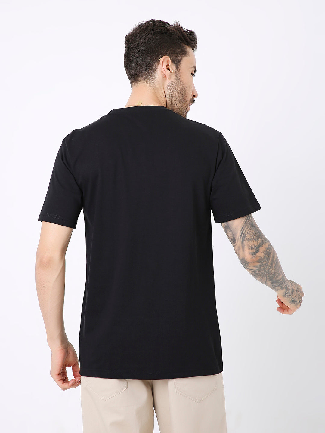 Black relaxed fit t-shirt with short sleeves, worn untucked, shown from the back.