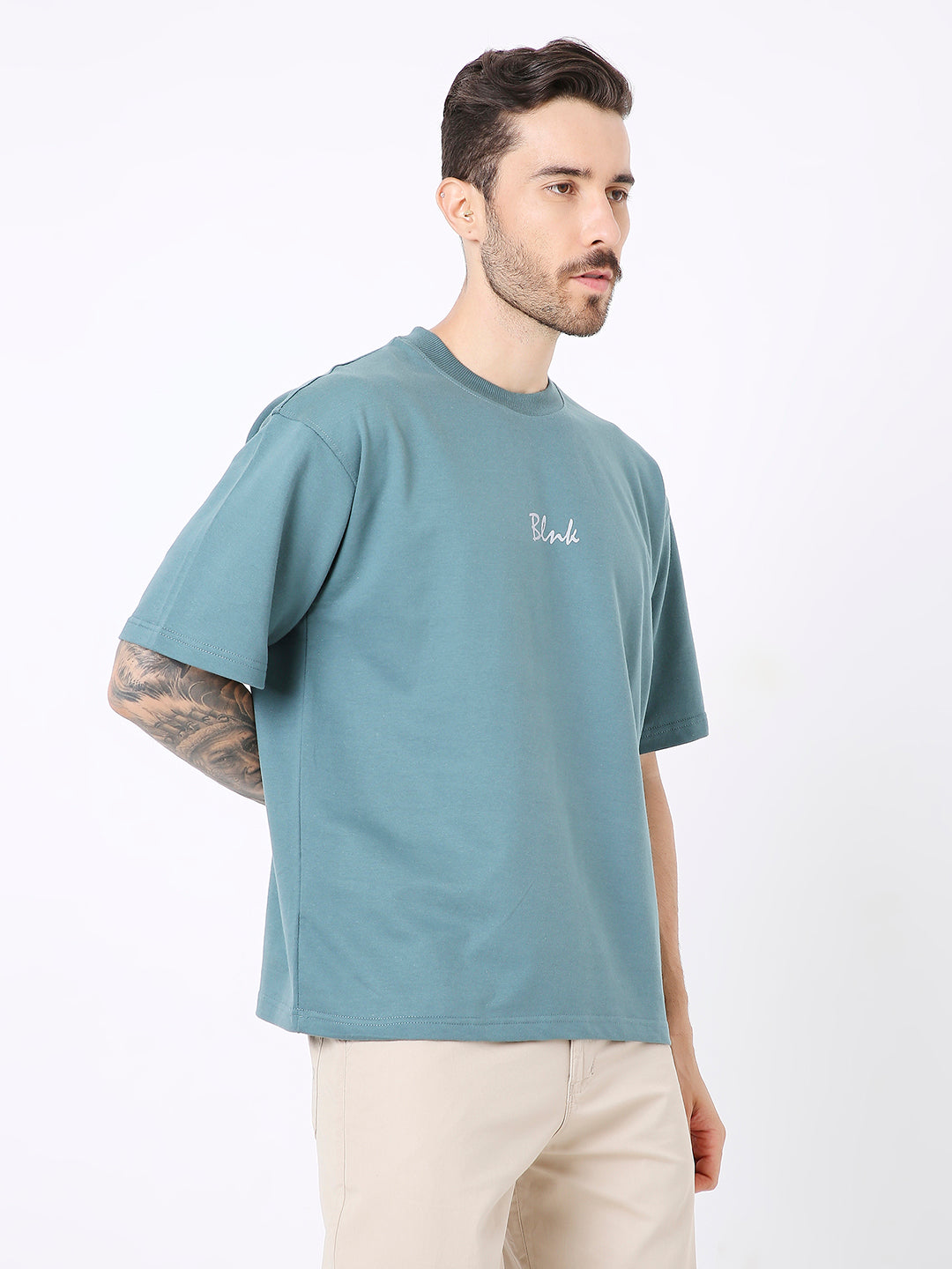Oversize sapphire blue T-shirt with small white printed logo on chest, short sleeves, relaxed fit.