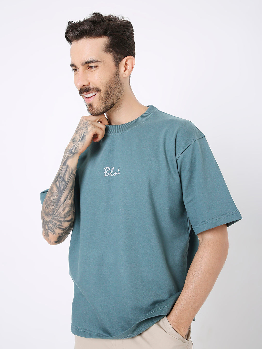 Oversize sapphire blue t-shirt with small white text print on chest, short sleeves, relaxed fit.