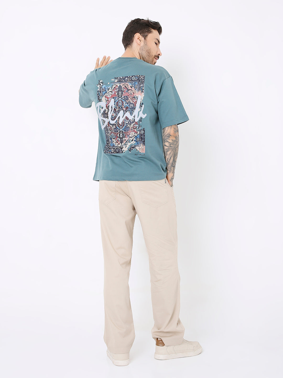 Oversize sapphire blue t-shirt with colorful floral and text graphic on back.