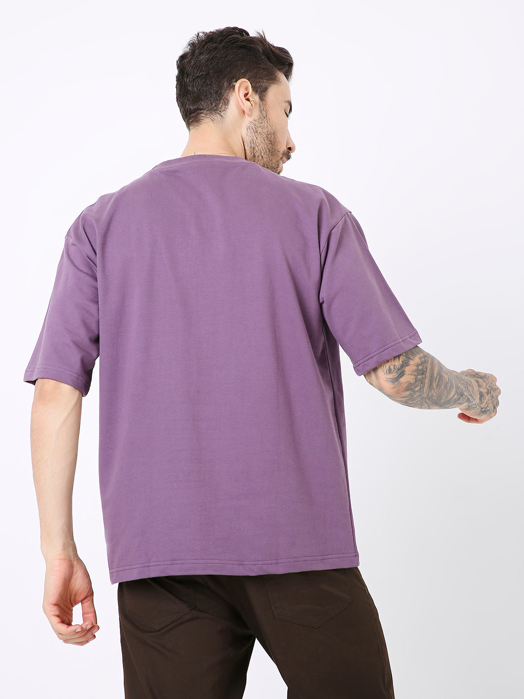 Oversize solid grape purple t-shirt with short sleeves on a male model viewed from back.