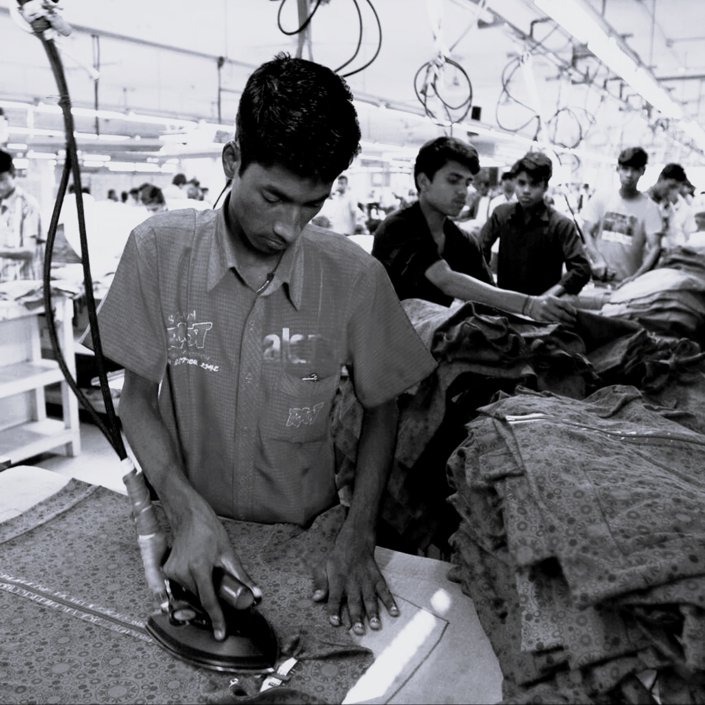 Person ironing clothes in the BLNK Clothing factory.