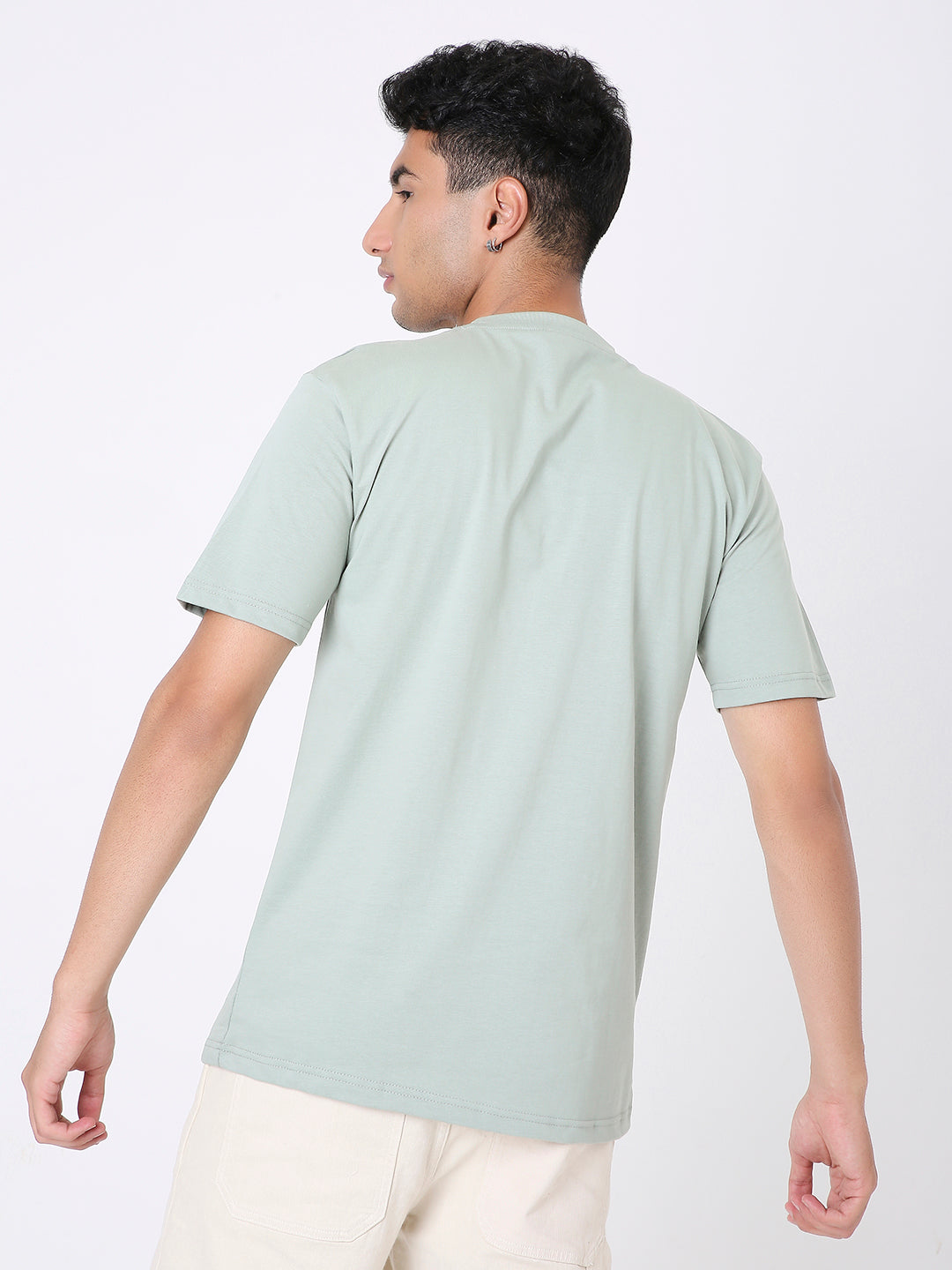 Relaxed fit sage green short-sleeve t-shirt on model shown from back.