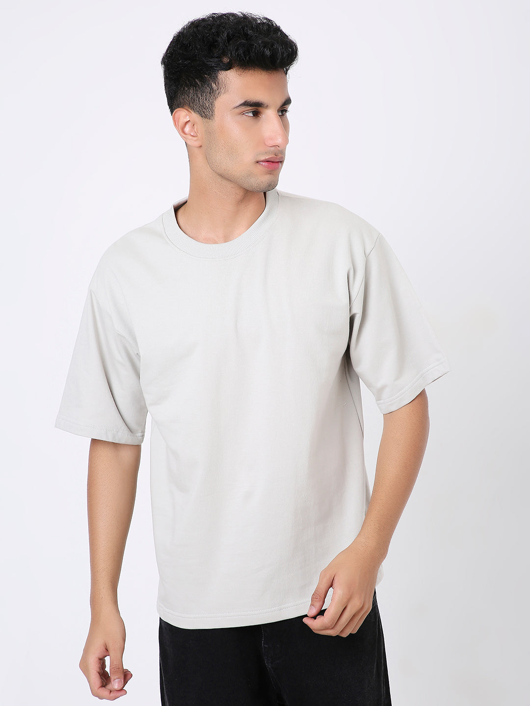 Light gray oversized short-sleeve T-shirt with a relaxed fit and crew neckline worn by male model.