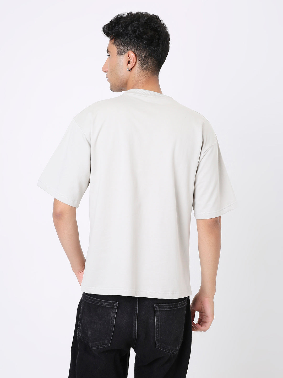 Oversize solid light gray t-shirt with short sleeves and crew neck viewed from the back.