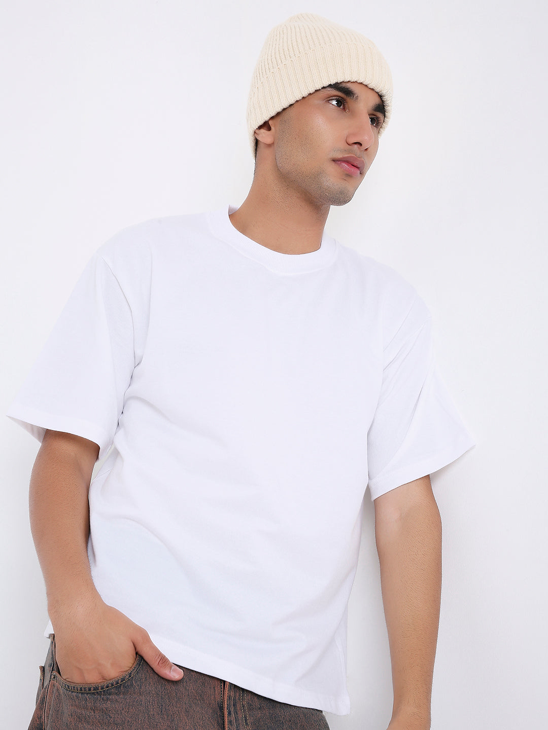 Oversize white solid cotton T-shirt with crew neckline and dropped shoulders.