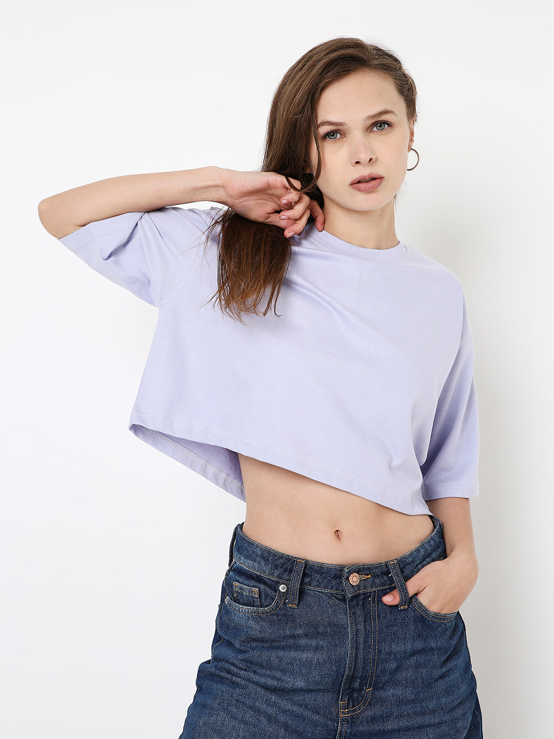 Oversize lavender crop top with wide short sleeves and loose fit on model.