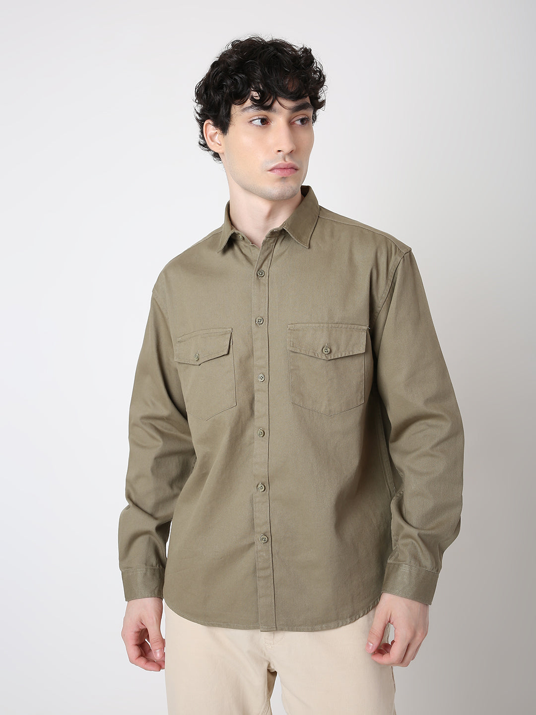 Man wearing a green shirt against a white background