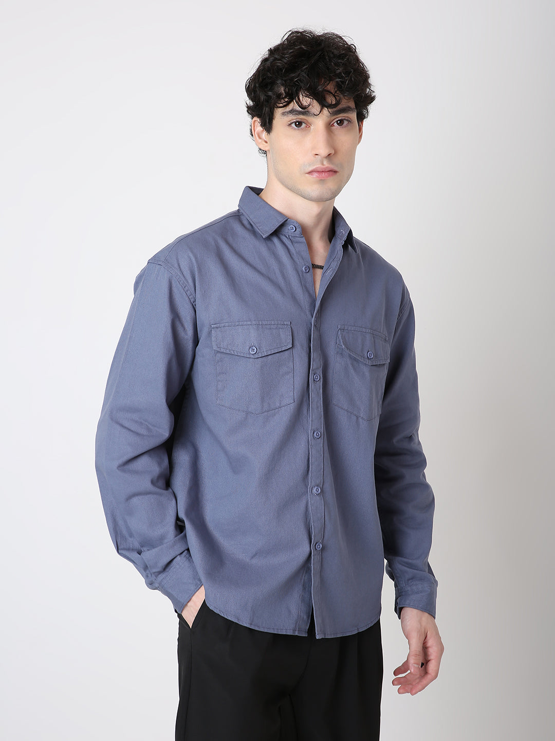Man wearing a blue shirt against a white background