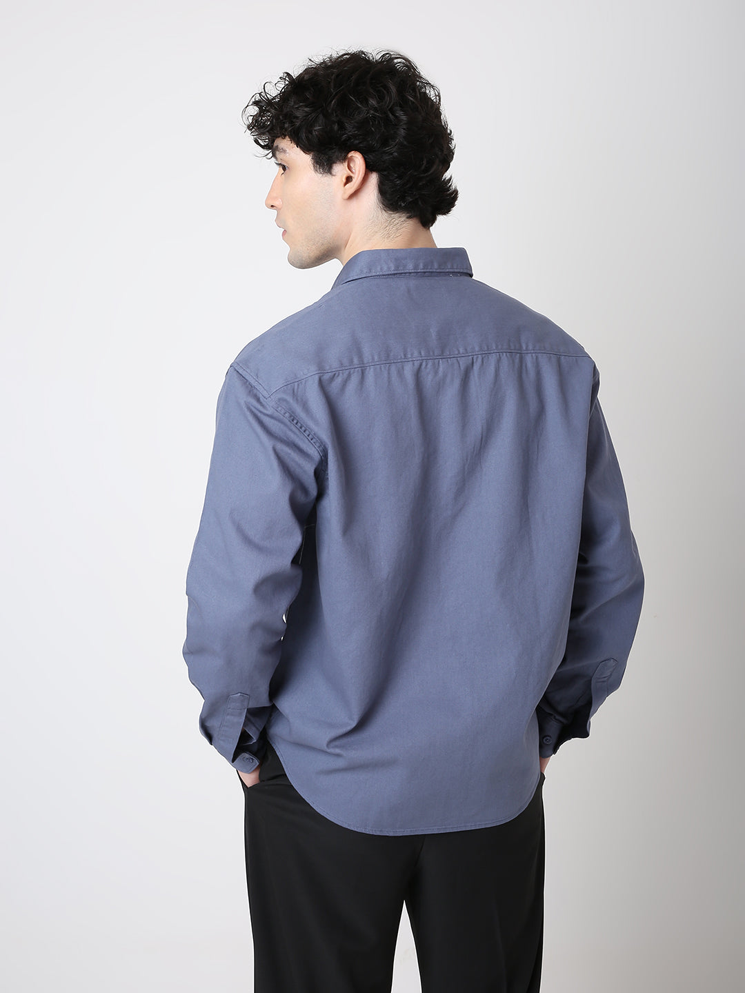 Person wearing a blue shirt against a white background