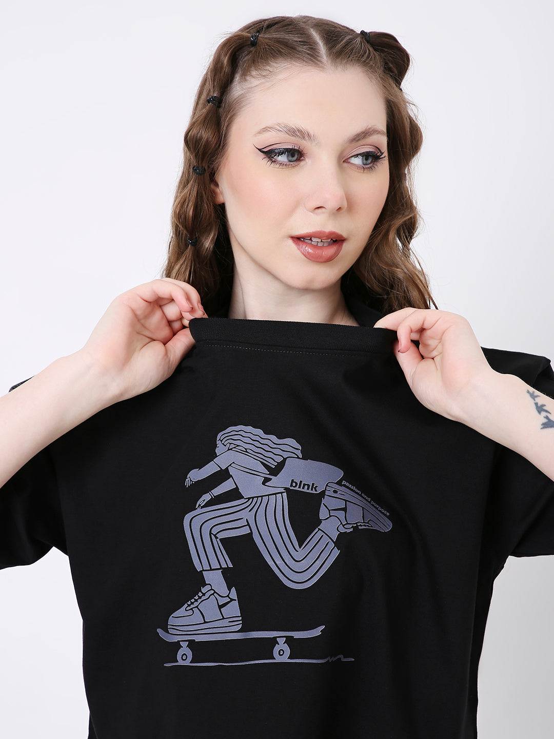 Oversize black crop top with gray outlined skateboarder graphic on front.