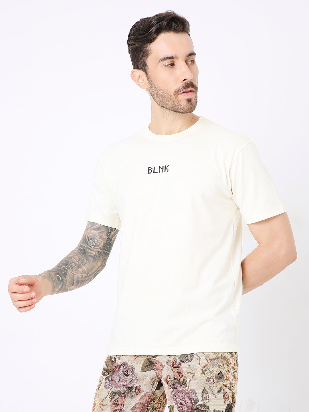 Off-white relaxed fit t-shirt with small black "BLNK" text on chest, crew neck, short sleeves.
