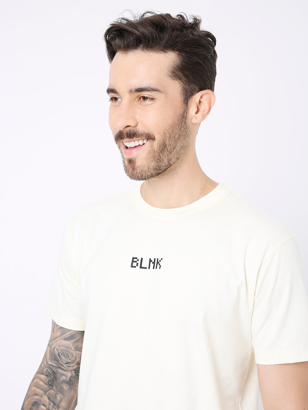 Off-white relaxed fit t-shirt with small black BLNK logo on chest and short sleeves.
