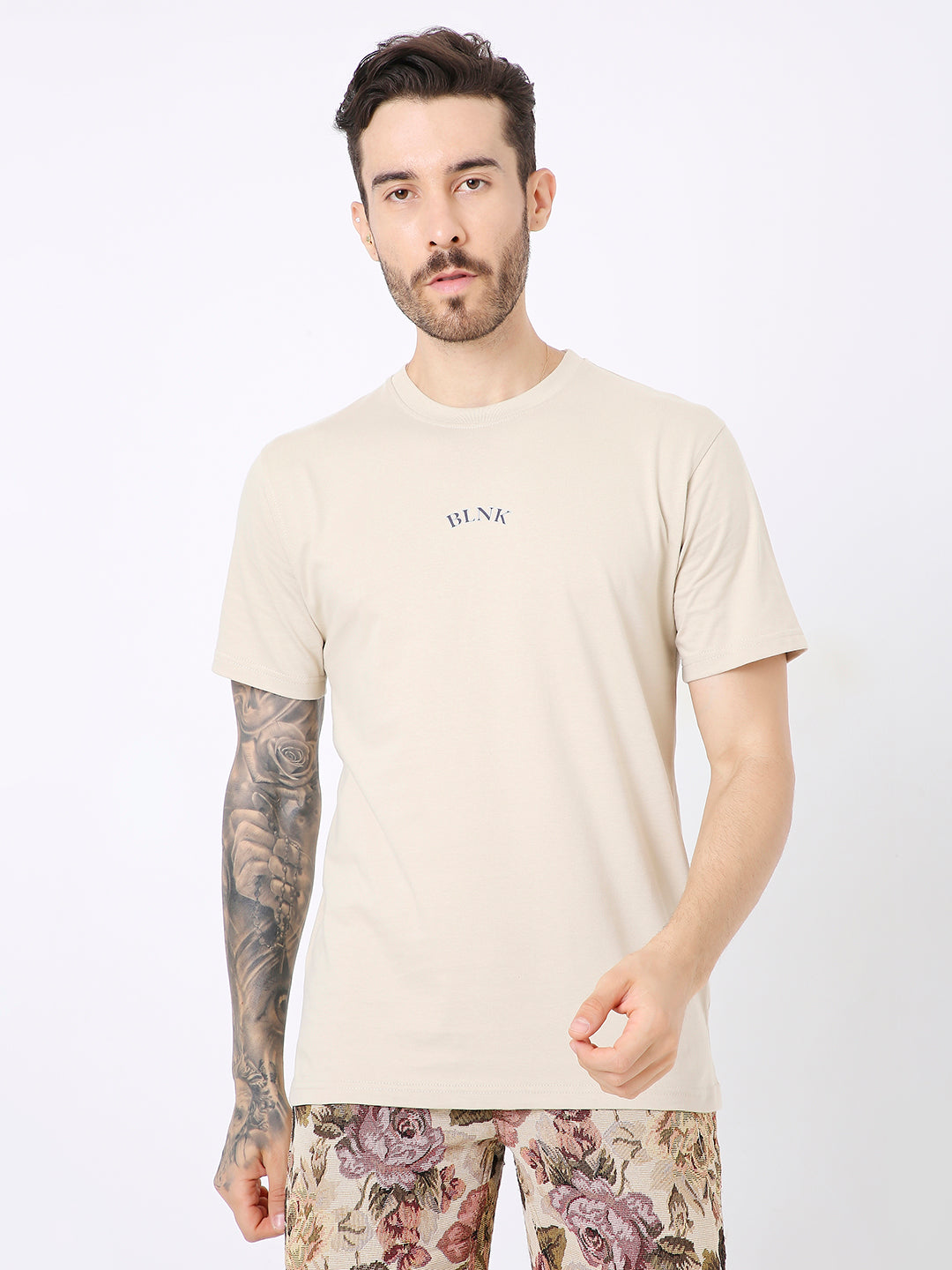 Beige relaxed fit t-shirt with small black text print on chest, short sleeves.