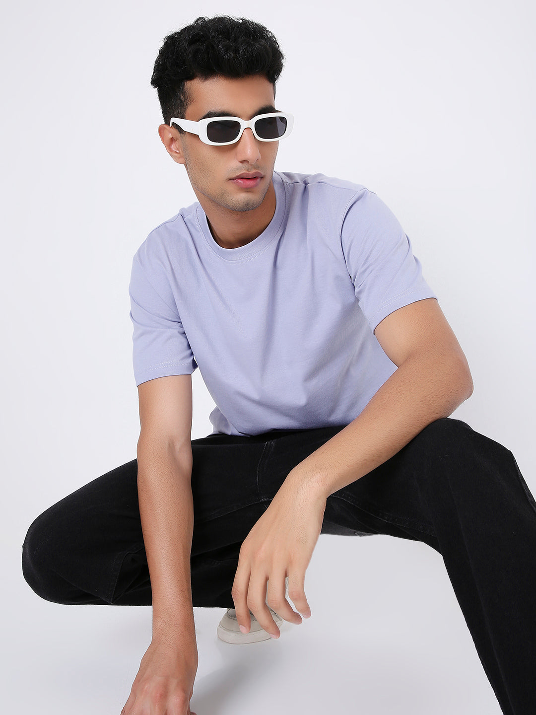Relaxed fit lavender short-sleeve t-shirt on male model with white sunglasses and black pants.